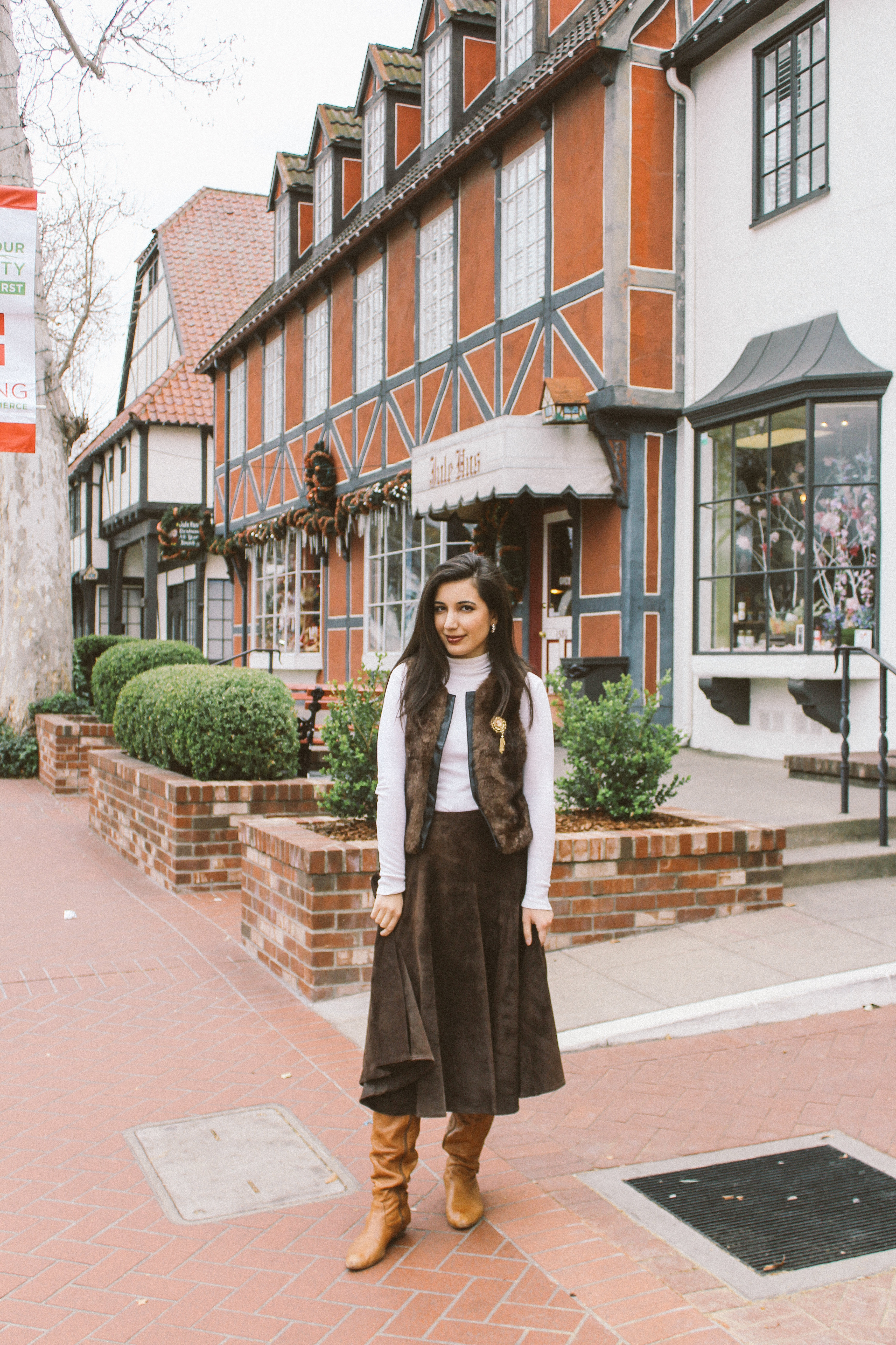 Solvang, CA, ALDO boots, fur vest, ootd, outfit of the day, California, CA, suede skirt, Jones New York, cameo brooch, white turtleneck, European, European outfit, lookbook, fashion blogger, travel