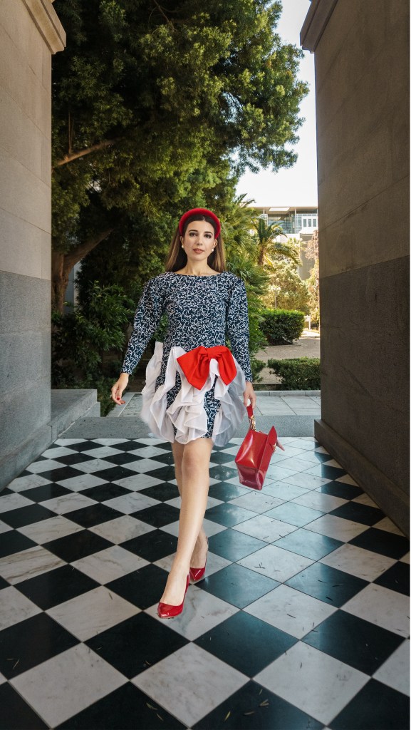 I could not believe that I was walking in such an avant garde gown past a league of legislators and tourists. In cherry-red pumps reminiscent of Dorothy’s ruby slippers, I strutted across the checkered tiles outside the California State Capitol, in place of a yellow brick road.